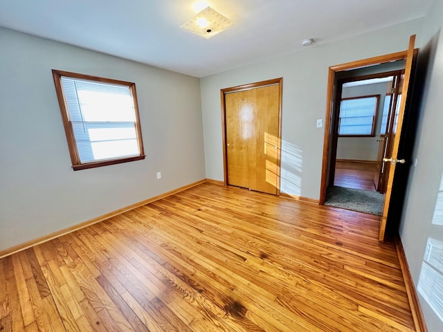 unfurnished bedroom featuring a closet and light hardwood / wood-style flooring