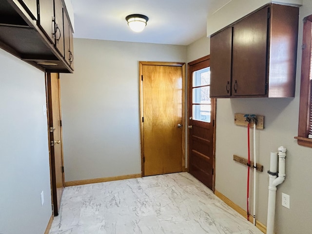 laundry area featuring cabinets