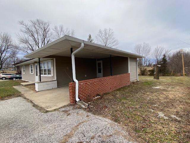 view of home's exterior featuring a carport