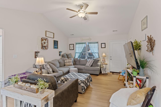 living room featuring ceiling fan, lofted ceiling, and light wood-type flooring