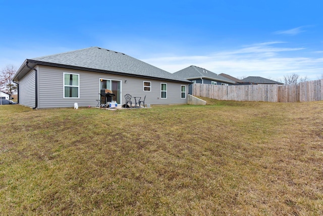 back of house with a lawn