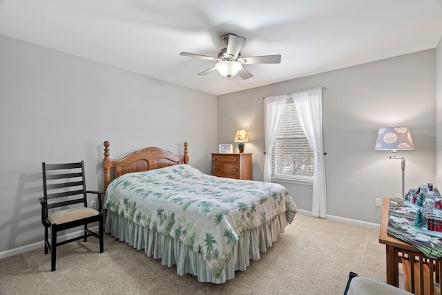 bedroom featuring a ceiling fan, light carpet, and baseboards