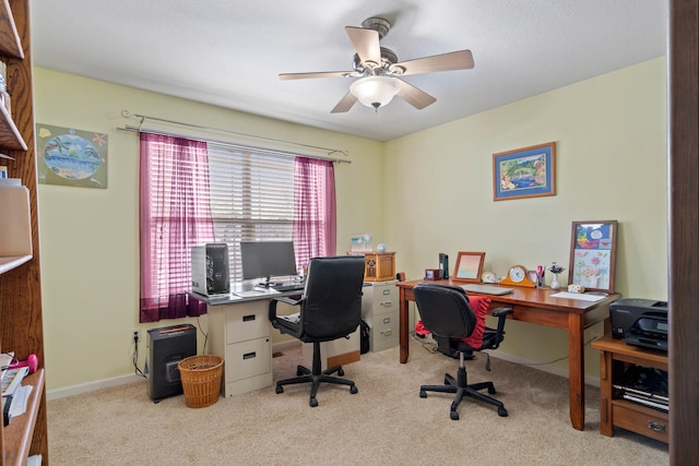 carpeted home office with ceiling fan