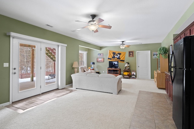 living room featuring ceiling fan and light colored carpet