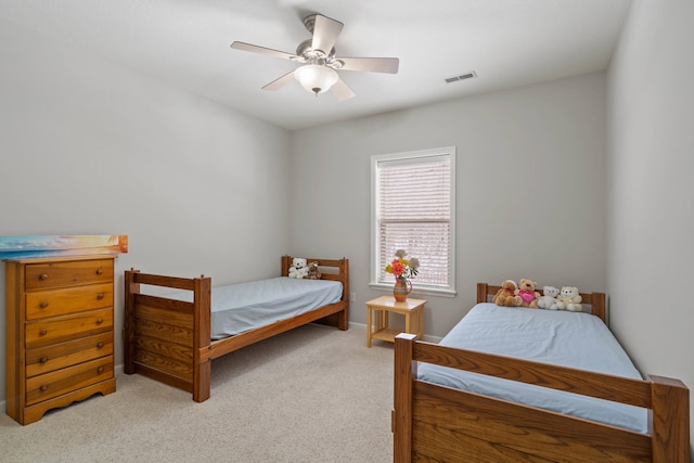 bedroom with ceiling fan and light carpet