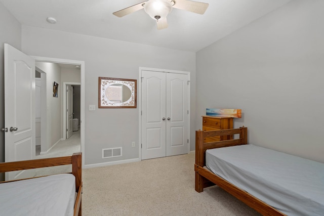 bedroom featuring baseboards, visible vents, light colored carpet, ceiling fan, and a closet