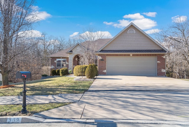 view of front of property with a garage, concrete driveway, brick siding, and a front lawn