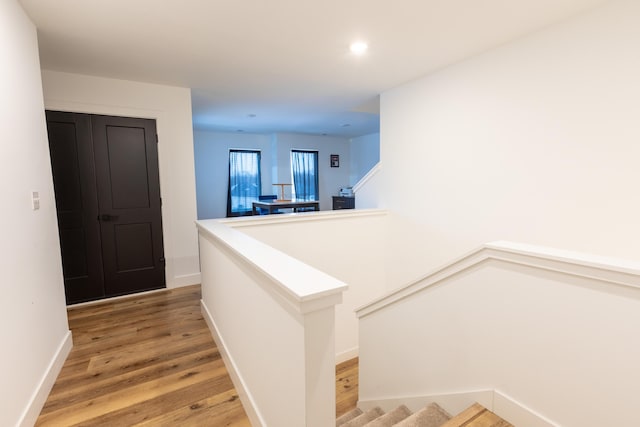 hall with hardwood / wood-style floors