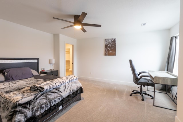 bedroom featuring ceiling fan, ensuite bath, and light carpet