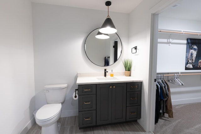 bathroom featuring toilet and vanity