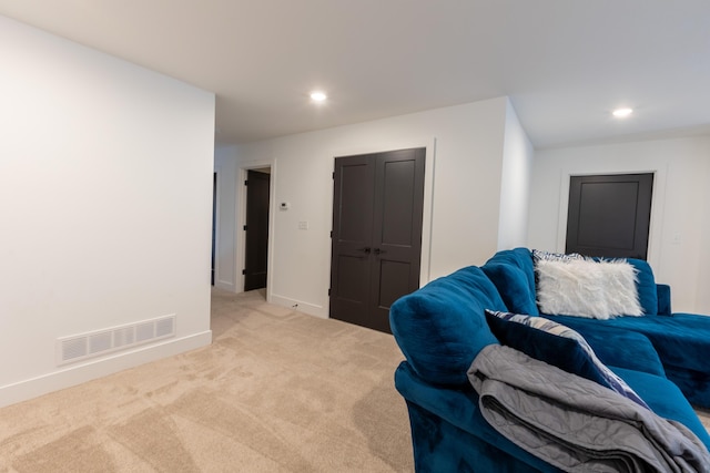 sitting room featuring light colored carpet