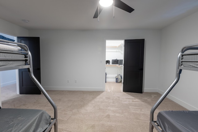 bedroom with ceiling fan and light colored carpet