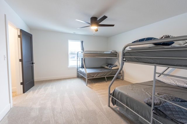 bedroom with ceiling fan and light colored carpet