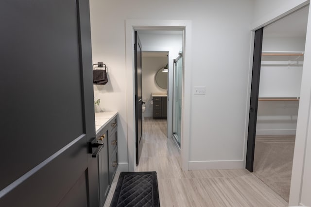 bathroom featuring walk in shower and vanity