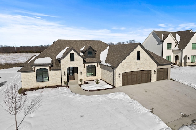 french provincial home with a garage