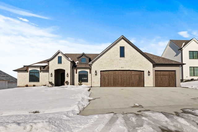 french country style house featuring a garage