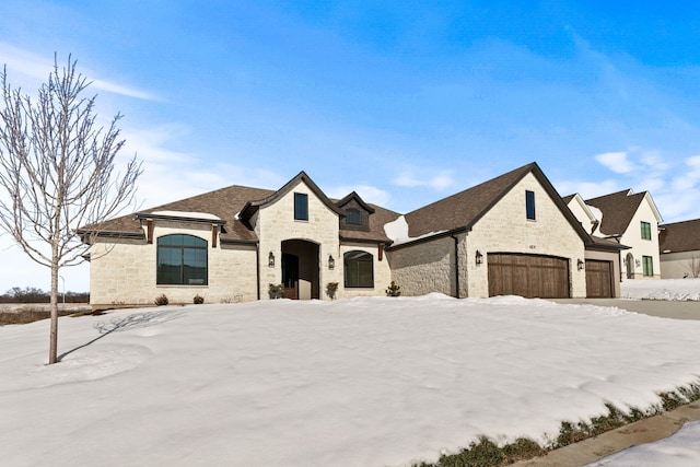 french country style house with a garage