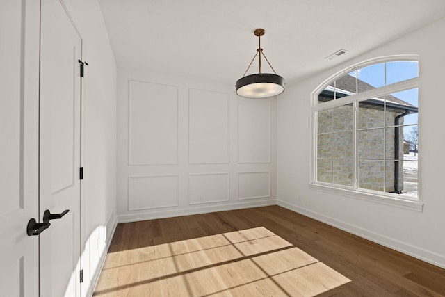 unfurnished dining area with hardwood / wood-style flooring