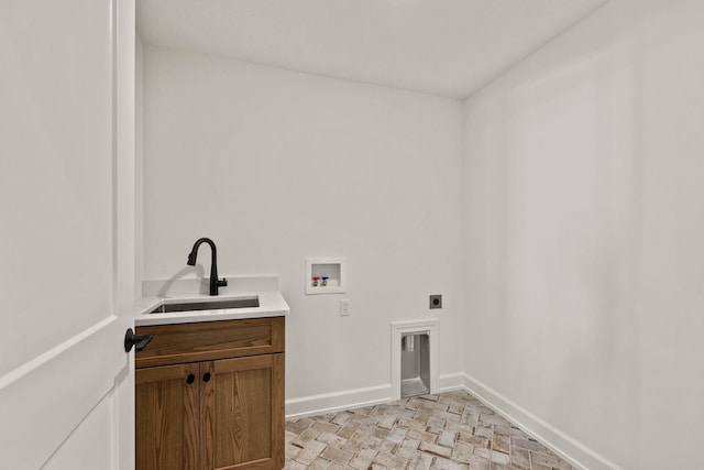 clothes washing area featuring cabinets, sink, hookup for an electric dryer, and washer hookup