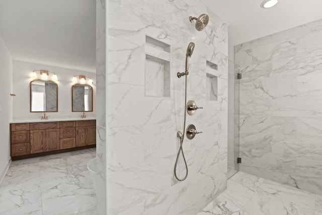 bathroom with vanity and a shower with door