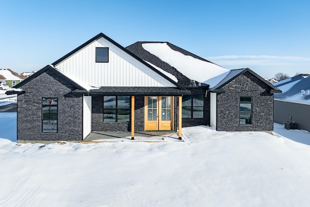 view of front of property with central AC and french doors