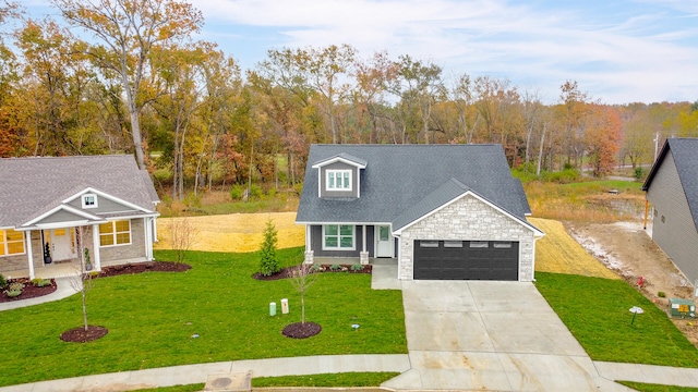 traditional-style home with a garage, covered porch, driveway, stone siding, and a front lawn