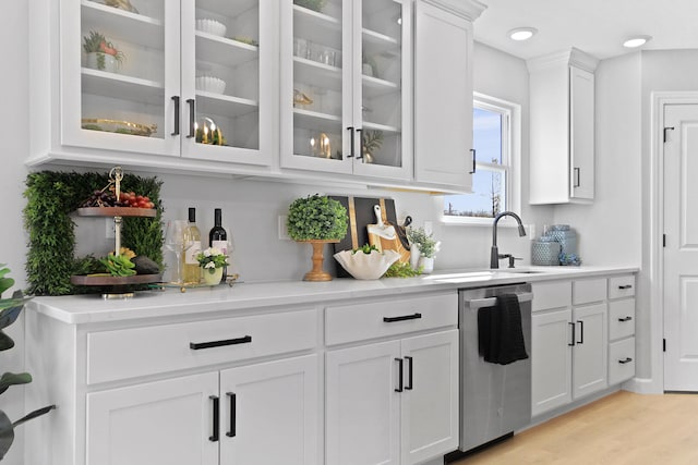 bar with light wood-type flooring, dishwasher, and recessed lighting