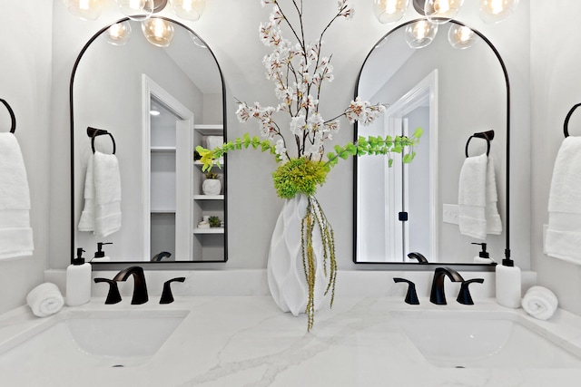 bathroom featuring a chandelier and vanity