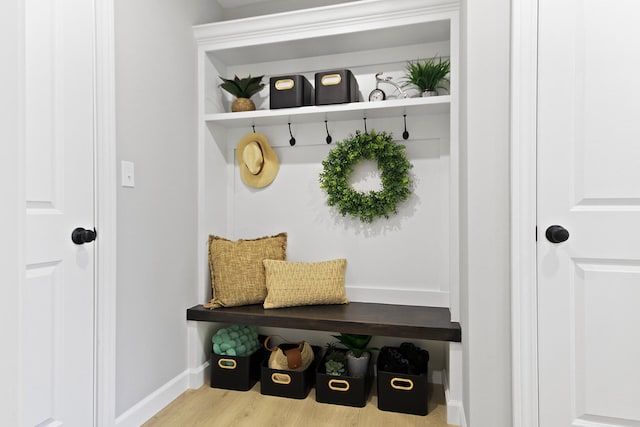 mudroom featuring baseboards and wood finished floors