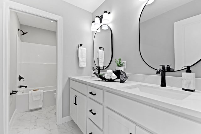 bathroom featuring marble finish floor, double vanity, a sink, and shower / tub combination