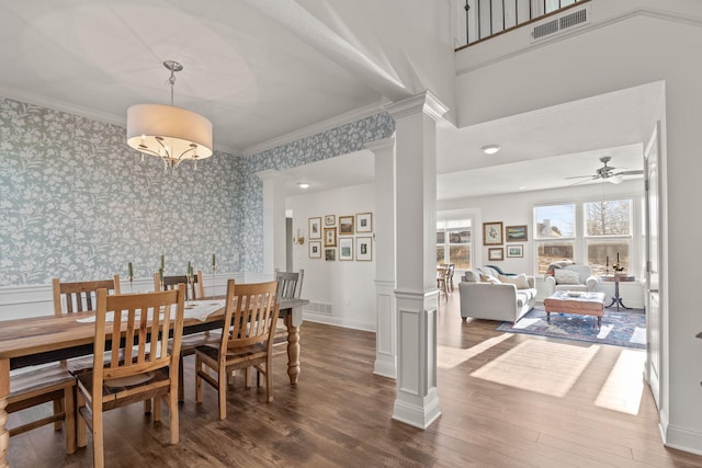 dining area featuring ornamental molding, decorative columns, dark hardwood / wood-style floors, and ceiling fan