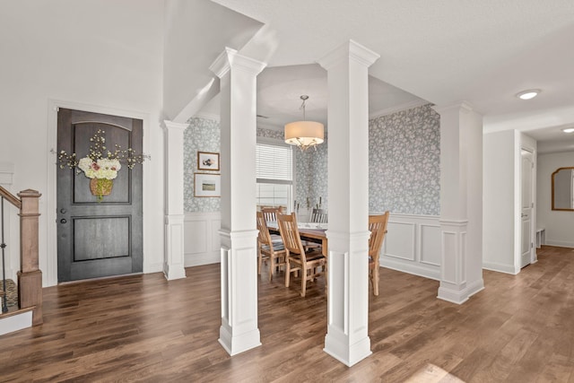 interior space with ornate columns and dark hardwood / wood-style floors