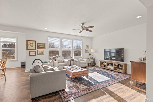 living room featuring wood-type flooring and ceiling fan