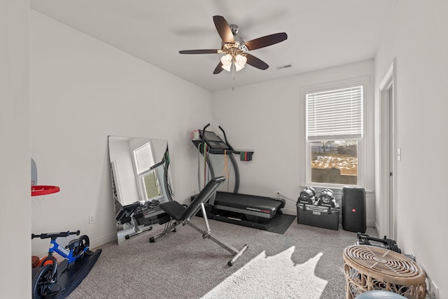 workout room with ceiling fan and carpet