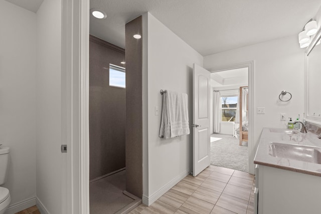 bathroom with tile patterned floors, vanity, and toilet