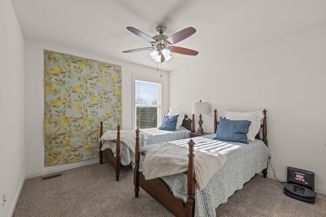 bedroom featuring ceiling fan and carpet