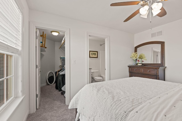 carpeted bedroom featuring ensuite bathroom and ceiling fan