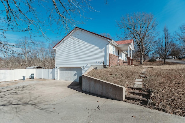 view of side of home with a garage