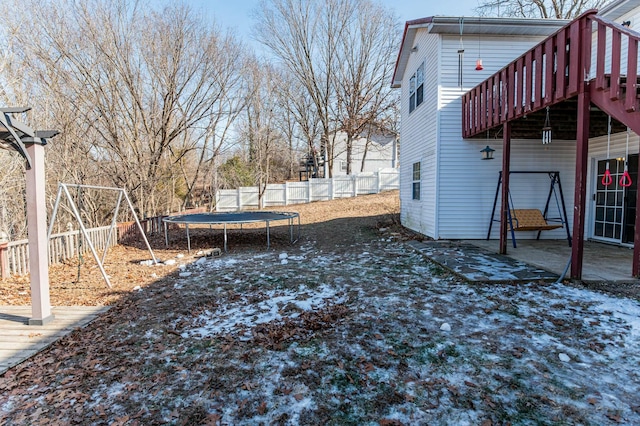 view of yard with a deck and a trampoline