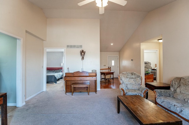 carpeted living room with ceiling fan and lofted ceiling