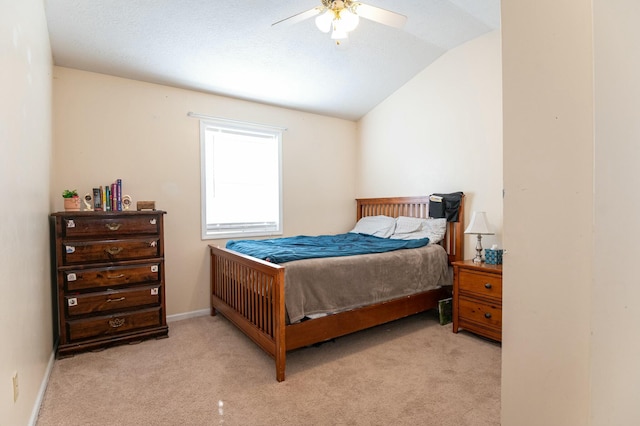 carpeted bedroom featuring ceiling fan and vaulted ceiling