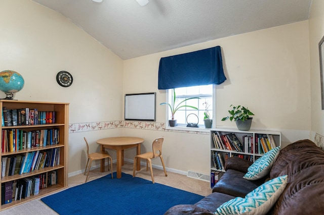 sitting room featuring carpet floors and lofted ceiling