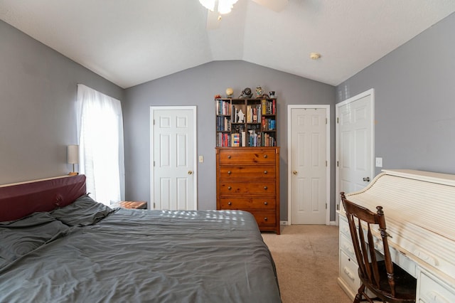 bedroom featuring ceiling fan, light colored carpet, and vaulted ceiling