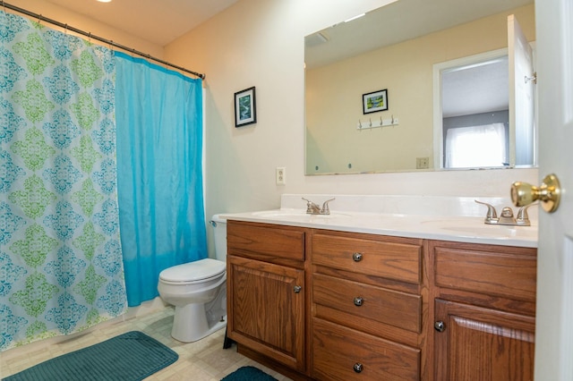 bathroom featuring toilet, walk in shower, and vanity