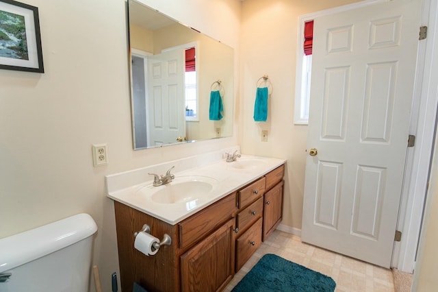 bathroom featuring toilet and vanity