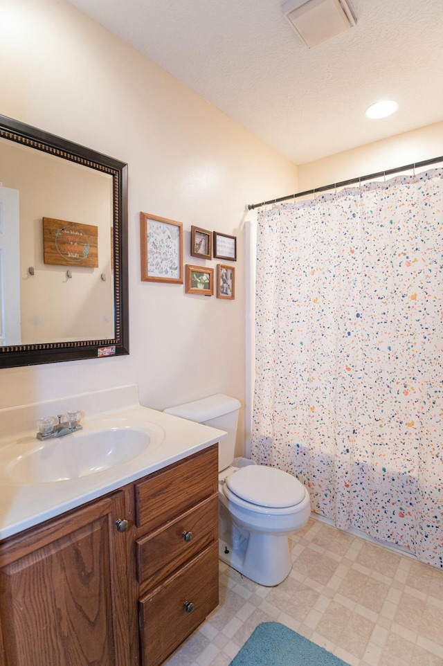 bathroom with toilet and vanity