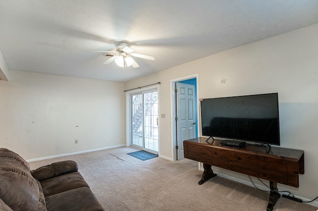 carpeted living room featuring ceiling fan