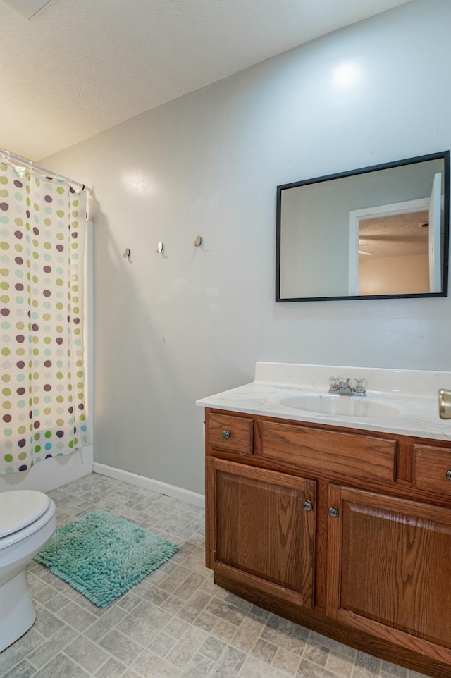 full bathroom featuring shower / bath combo, toilet, and vanity