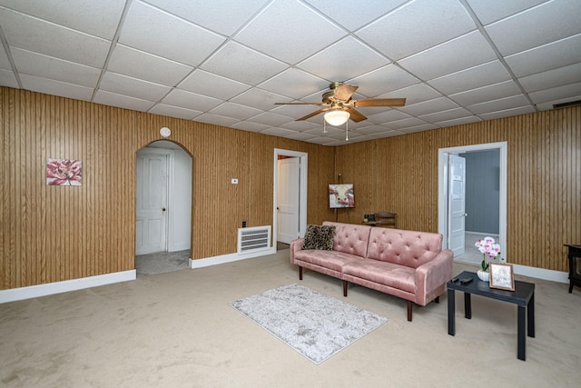 carpeted living room with ceiling fan