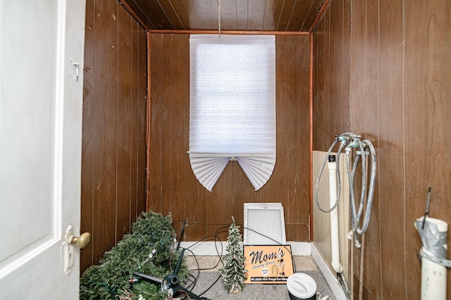 bathroom featuring wooden ceiling and wooden walls